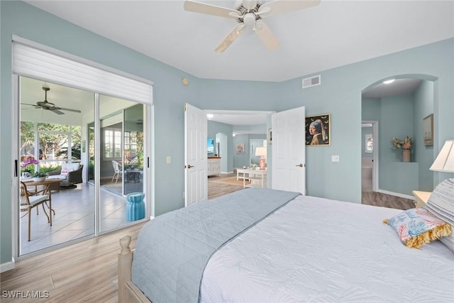 bedroom featuring arched walkways, ceiling fan, visible vents, access to exterior, and light wood finished floors