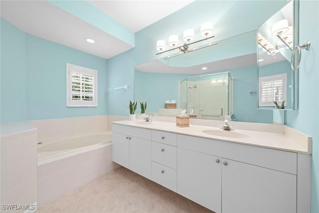 full bathroom with a stall shower, a garden tub, a wealth of natural light, and a sink