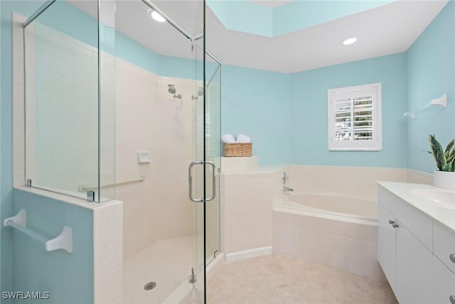 bathroom with tile patterned flooring, recessed lighting, vanity, a bath, and a stall shower