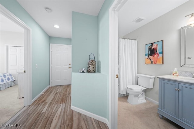 bathroom featuring toilet, recessed lighting, vanity, visible vents, and baseboards