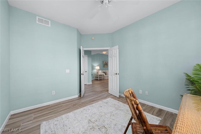 office featuring visible vents, ceiling fan, baseboards, and wood finished floors