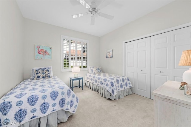 bedroom with light carpet, a closet, and a ceiling fan