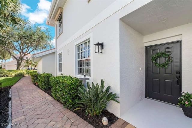 entrance to property with stucco siding