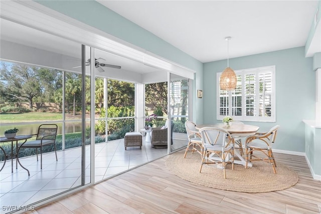 sunroom / solarium with a ceiling fan and a wealth of natural light