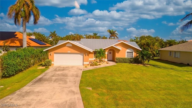 single story home featuring metal roof, a garage, concrete driveway, stucco siding, and a front lawn