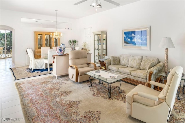 living area with ceiling fan with notable chandelier