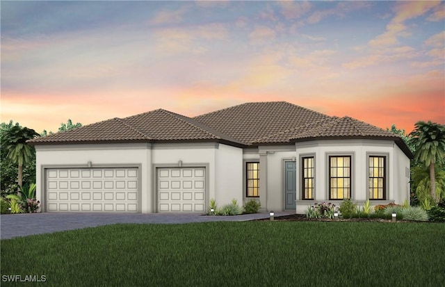 view of front facade featuring a garage, a tiled roof, decorative driveway, a front lawn, and stucco siding