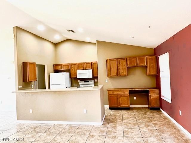 kitchen featuring brown cabinets, light tile patterned floors, light countertops, white appliances, and a peninsula