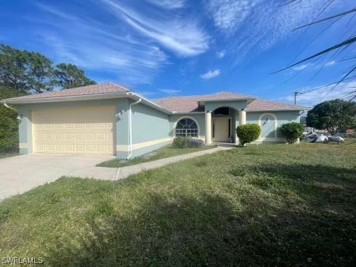 ranch-style home with concrete driveway, a front lawn, an attached garage, and stucco siding