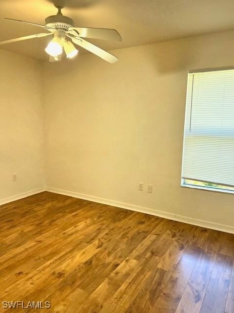 unfurnished room featuring ceiling fan, wood finished floors, and baseboards