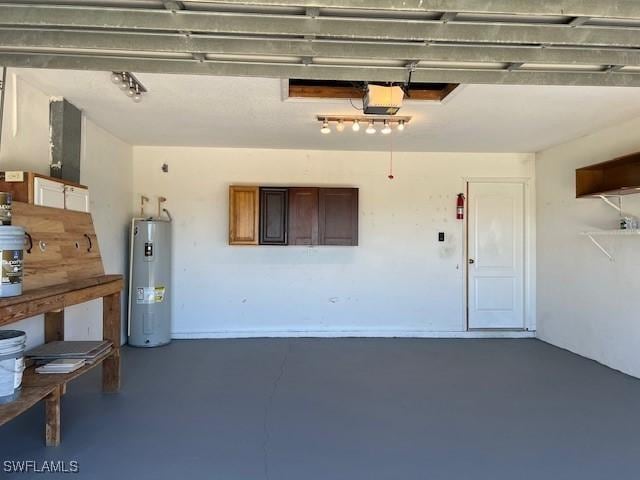 garage with water heater and a garage door opener