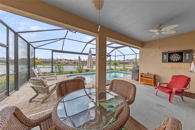 4178 Bloomfield St, Fort Myers, FL 33916 - view of patio / terrace with a ceiling fan, a water view, outdoor dining space, an outdoor pool, and glass enclosure