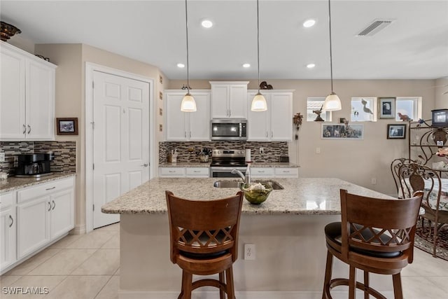4178 Bloomfield St, Fort Myers, FL 33916 - kitchen with appliances with stainless steel finishes, a sink, tasteful backsplash, white cabinetry, and recessed lighting