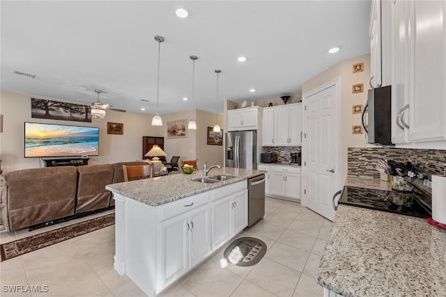 4178 Bloomfield St, Fort Myers, FL 33916 - kitchen with appliances with stainless steel finishes, tasteful backsplash, open floor plan, white cabinets, and light tile patterned flooring
