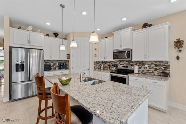 4178 Bloomfield St, Fort Myers, FL 33916 - kitchen with stainless steel appliances, a sink, an island with sink, white cabinetry, and recessed lighting