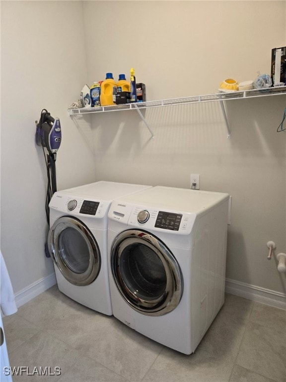 4178 Bloomfield St, Fort Myers, FL 33916 - laundry area with independent washer and dryer, light tile patterned floors, and baseboards