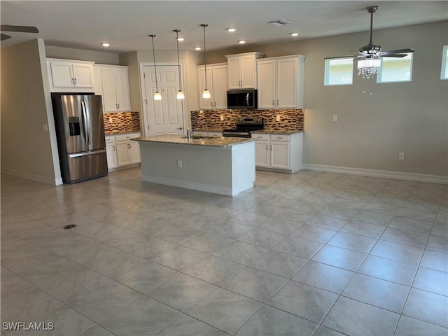 4178 Bloomfield St, Fort Myers, FL 33916 - kitchen with stainless steel appliances, a ceiling fan, tasteful backsplash, light stone countertops, and white cabinets