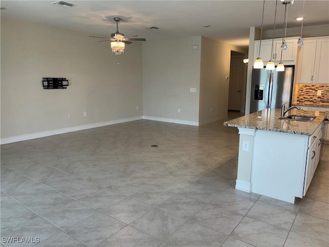 4178 Bloomfield St, Fort Myers, FL 33916 - kitchen with stainless steel fridge, a sink, ceiling fan, open floor plan, and light stone countertops