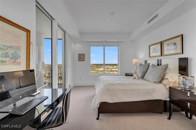 carpeted bedroom with baseboards, visible vents, access to outside, and a raised ceiling