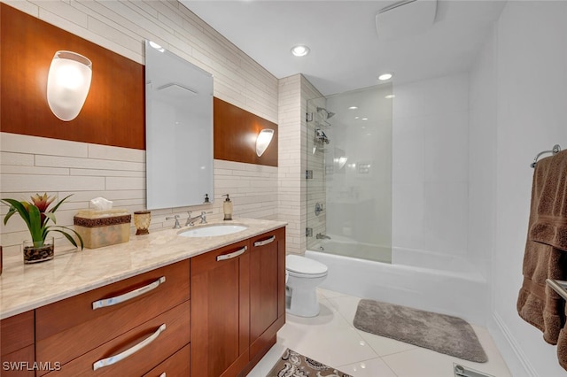 full bath featuring toilet, tile walls, vanity, shower / bathing tub combination, and tile patterned floors