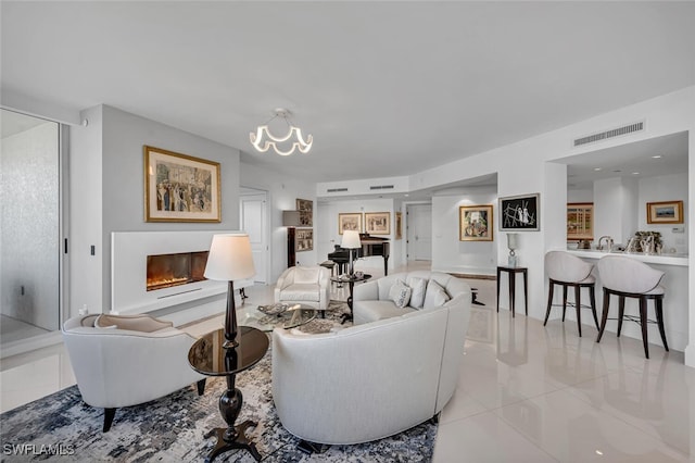 living area with a glass covered fireplace and visible vents