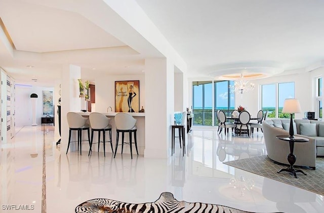 interior space with marble finish floor and an inviting chandelier