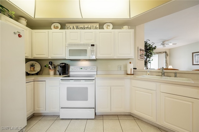 kitchen featuring light countertops, white appliances, a sink, and white cabinetry