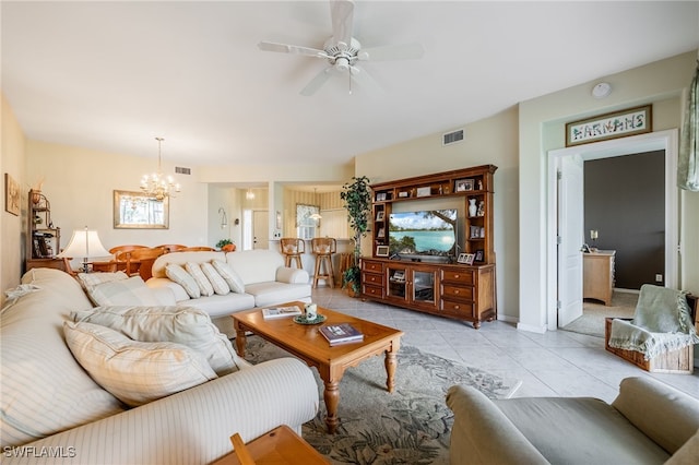 living room featuring light tile patterned floors, ceiling fan with notable chandelier, visible vents, and baseboards