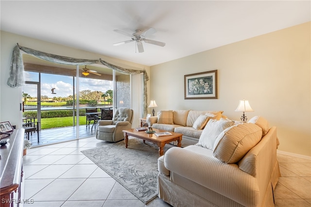 living room with light tile patterned floors, ceiling fan, and baseboards