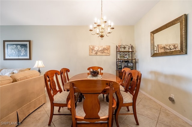 dining area featuring light tile patterned flooring, an inviting chandelier, and baseboards