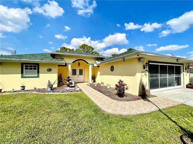 ranch-style home with driveway, an attached garage, a patio area, a front lawn, and stucco siding