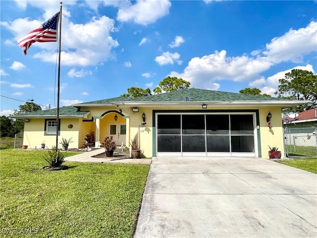 ranch-style house featuring stucco siding, concrete driveway, a front yard, fence, and a garage