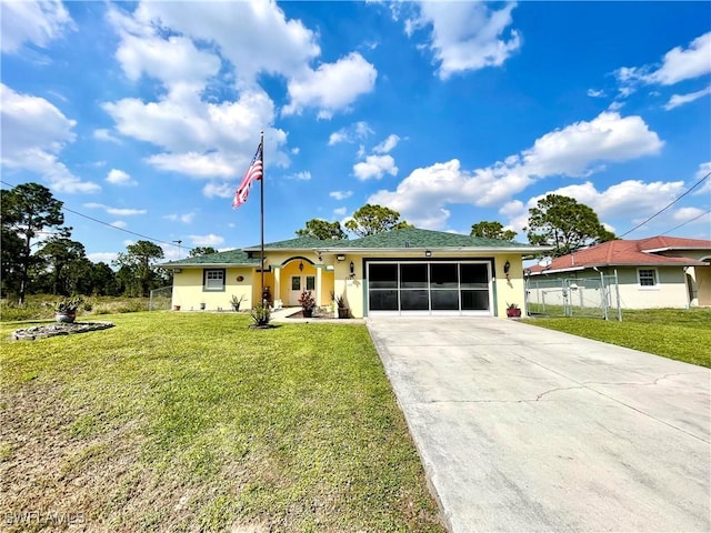 ranch-style home featuring an attached garage, fence, driveway, stucco siding, and a front yard