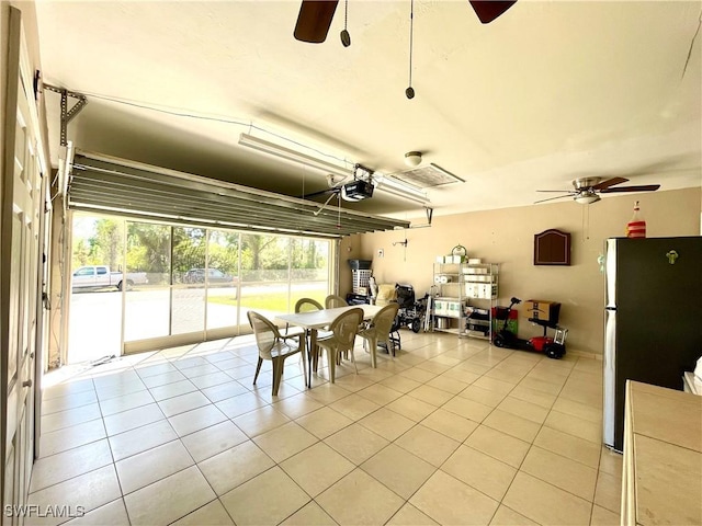 dining room with light tile patterned floors and a ceiling fan