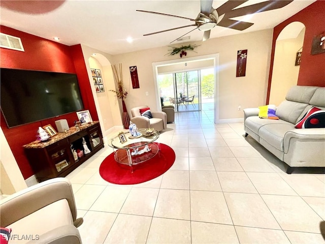 tiled living room with baseboards, visible vents, arched walkways, a ceiling fan, and recessed lighting