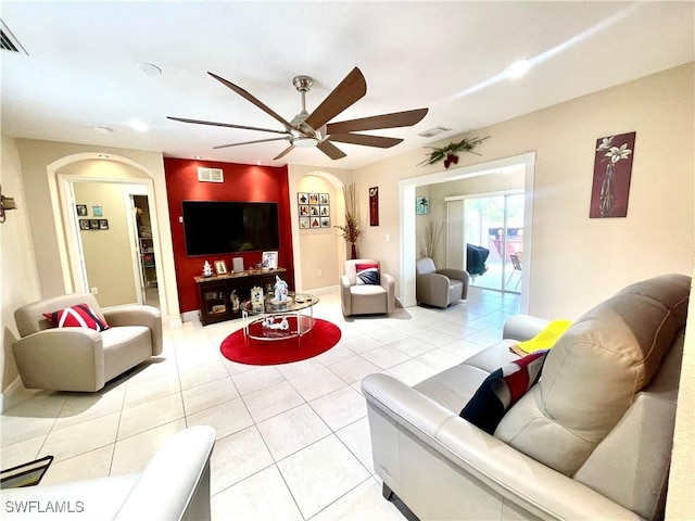 living area with visible vents, ceiling fan, and light tile patterned flooring