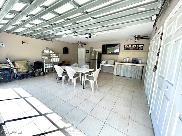 dining area featuring a ceiling fan and light tile patterned flooring