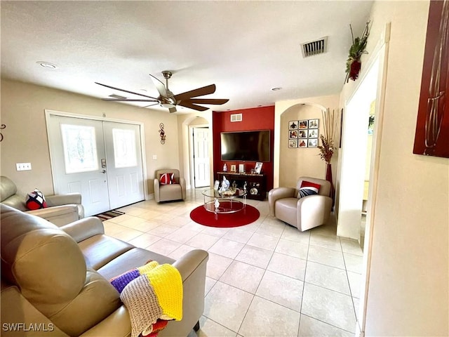 living area featuring a ceiling fan, visible vents, french doors, and light tile patterned flooring