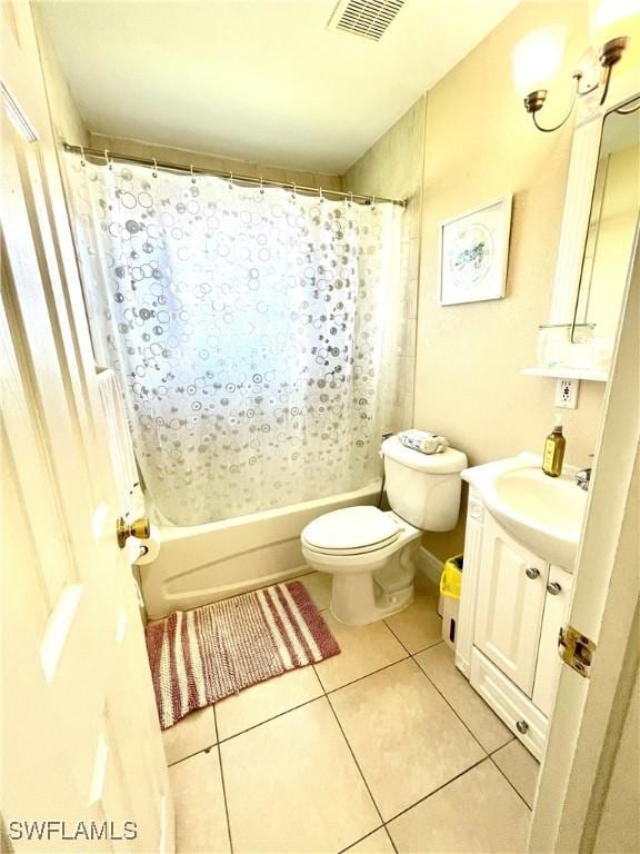 bathroom with visible vents, toilet, shower / tub combo, vanity, and tile patterned floors