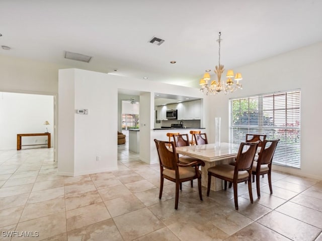 dining room with baseboards, visible vents, a notable chandelier, and light tile patterned flooring