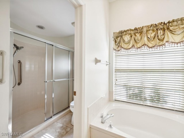 full bath featuring a bath, a stall shower, tile patterned flooring, and toilet