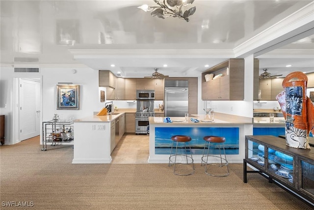 kitchen with light countertops, a breakfast bar, high end appliances, and modern cabinets