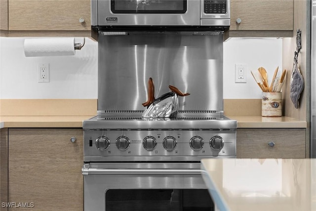 details with stainless steel appliances and light countertops