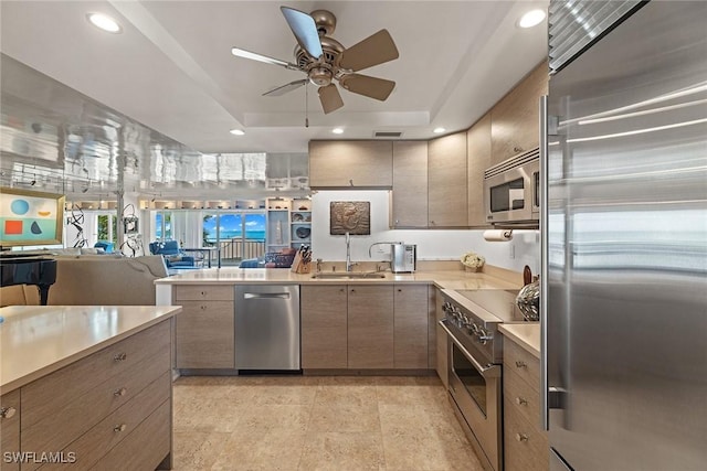 kitchen featuring appliances with stainless steel finishes, recessed lighting, light countertops, and a sink