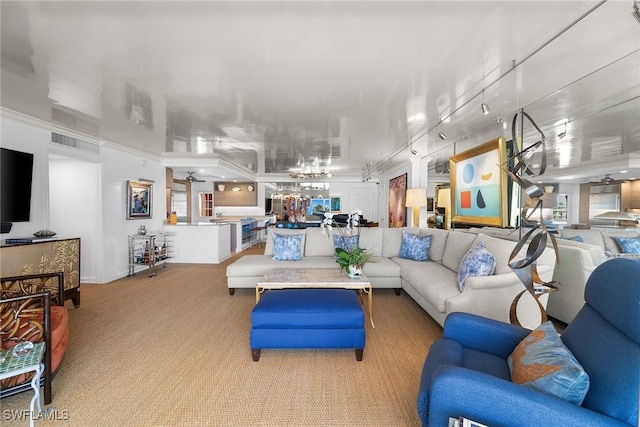 living room featuring visible vents, light carpet, and track lighting