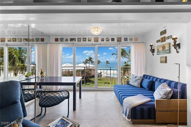 living area featuring a water view and tile patterned floors