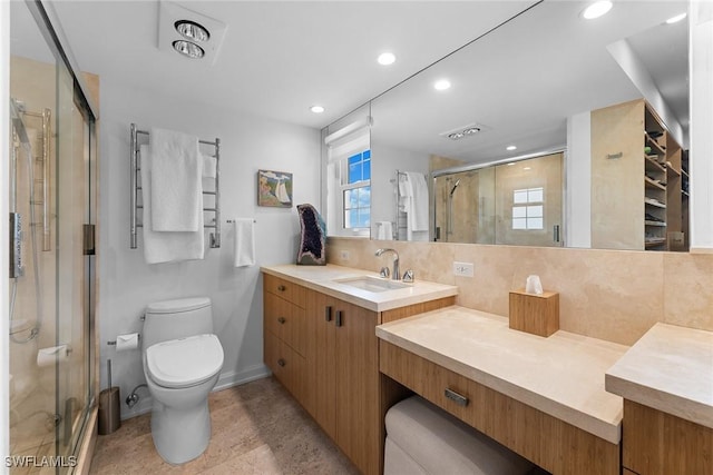 bathroom with visible vents, backsplash, toilet, a stall shower, and vanity