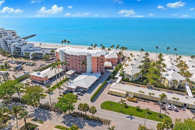 drone / aerial view featuring a water view and a view of the beach