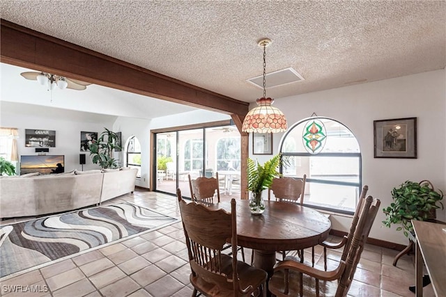 dining room with a textured ceiling, light tile patterned flooring, a ceiling fan, and baseboards