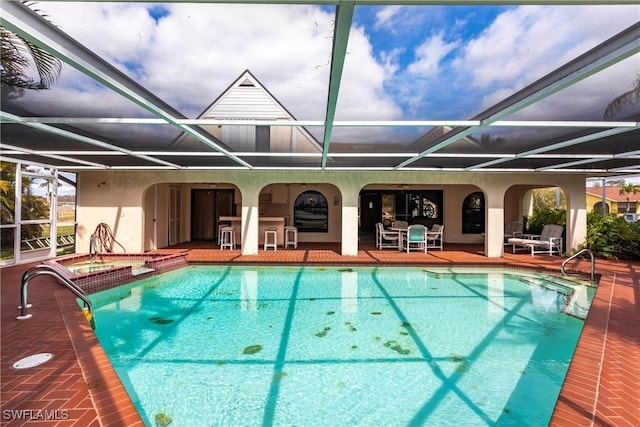 pool featuring a patio and glass enclosure